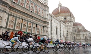 Cyclists ride through a soggy Florence during the men's elite race, at the road cycling world championships.