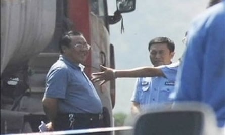 Yang Dacai, dubbed Brother Watch, shown smiling at the scene of a horror road crash