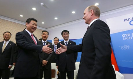 Vladimir Putin shakes hands with Xi Jinping at a meeting at the G20 summit
