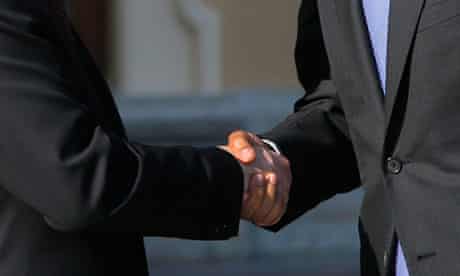Vladimir Putin and Barack Obama shake hands