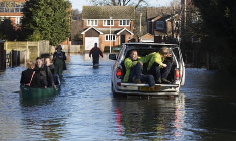 Residents wade through the streets of Purley in Reading. Scientists say David Cameron was right to link recent weather to climate change