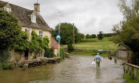 Wading through floods in Swinbrook, Oxfordshire
