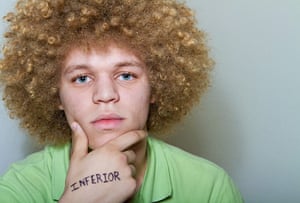 Big Picture - What I Be: Young man with the word inferior written on hand