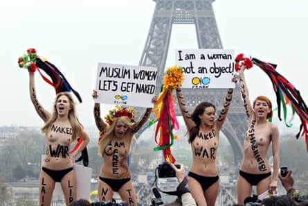 Naked women take part in a rally marking international day to end