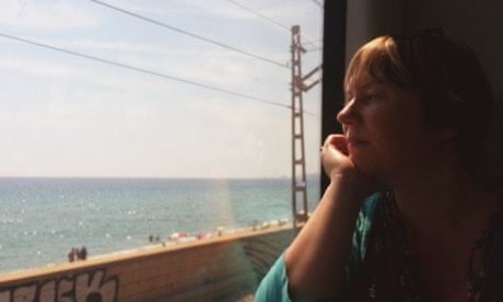 Iona Lunan looks at sea through window