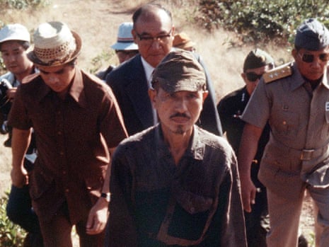 Hiroo Onoda, still carrying his sword, walks out of the Philippine jungle to surrender in 1974.