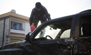 Kabul attack: An Afghan man removes a windscreen