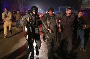 Kabul attack: Afghan police forces assist an injured man