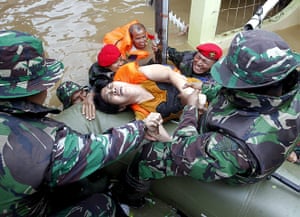 Weekend in pictures: Jakarta, Indonesia: Army Special Forces pull a flood victim onto a rubber d
