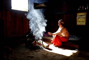 Weekend in pictures: Homain, Burma: A Buddhist nun sits by the fire to keep warm