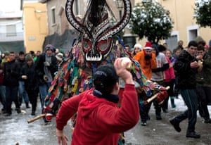 Weekend in pictures: Piornal, Spain: A man throws a turnip at the Jarramplas as he makes his way