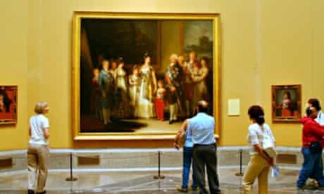 Tourists admire Charles IV and family by Goya at the Madrid Museo del Prado