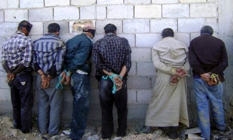 Detained Syrian men, blindfolded and handcuffed, in Qusair, near Homs