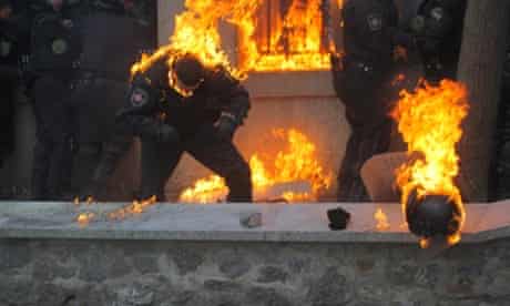 Members of the Ukrainian riot police caught in a fire due to the gasoline bombs hurled by anti-government protestors during the clashes in central Kiev, Ukraine.
