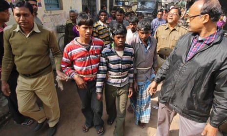 Indian police personnel escort men who are accused of a gang-rape to a court at Birbhum, India.