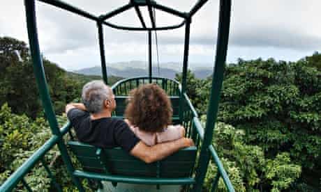 Hanif Kureishi and his partner ride through a rainforest in a cable car
