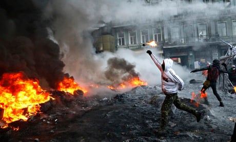 A protester throws a molotov cocktail during clashes with police in Kiev, Ukraine