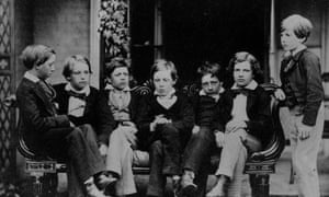 A photograph of a young Lewis Carroll (centre), sitting with friends.