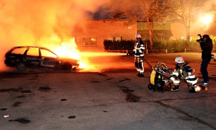 A car burning after riots in Stockholm in 2013.