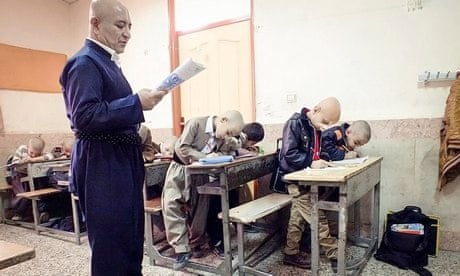 Ali Mohammadian and his pupils, who shaved their heads in solidarity with a bullied pupil