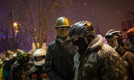 Anti-government protestors in various helmets gather in Independence Square in Kiev, Ukraine. Ukraine's parliament is holding a special session called over continuing unrest in the country and Prime Minister Mykola Azarov has offered to resign.