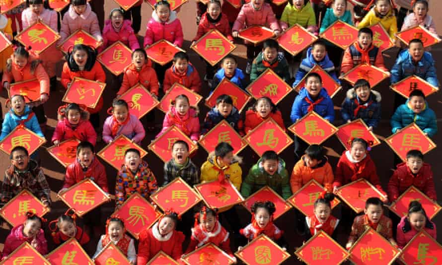Children with paper-cuts with the Chinese character Ma, meaning Horse