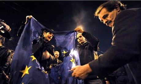 Greek demonstrators burn an EU flag