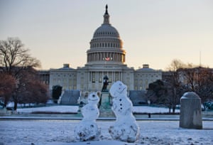 Snowmen sit in front of the Capitol in Washington DC.