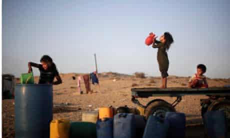 Palestinian children drink water in Younis