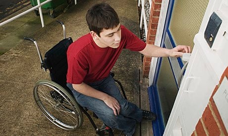 Man in wheelchair opening door
