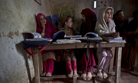 Afghan refugees and internally displaced Pakistani girls attend their classes at a makeshift school.