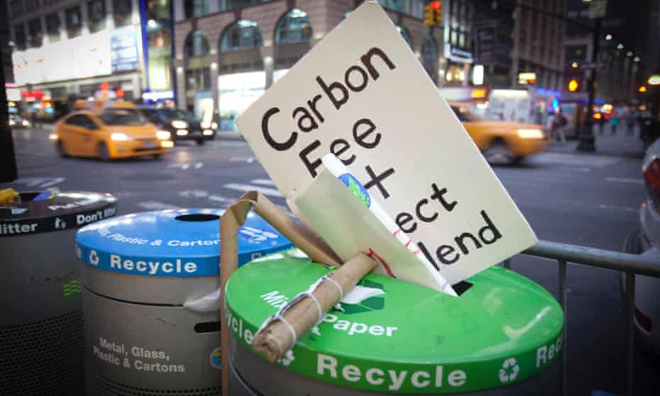 A sign that had been carried during the "People's Climate March" is discarded into the trash after the march in the Manhattan borough of New York 