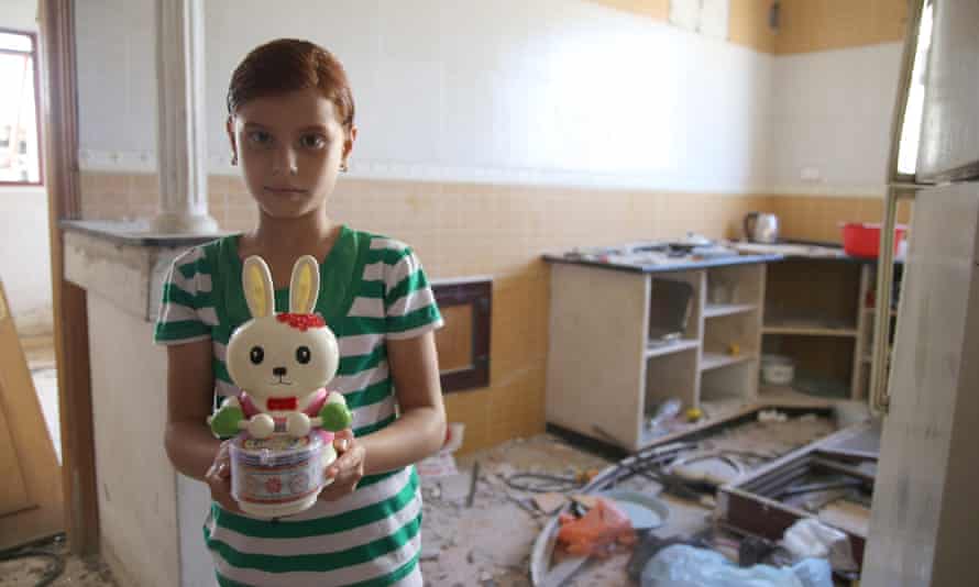 Aleh: "This is my second-favourite toy, Foo. She sleeps with me at night and I covet her like she is my own daughter:" Aleh’s family now sleep in the bathroom, one of the only rooms left in their house.  Aleh’s favourite toy, a bridesmaid doll, was lost in the wreckage.