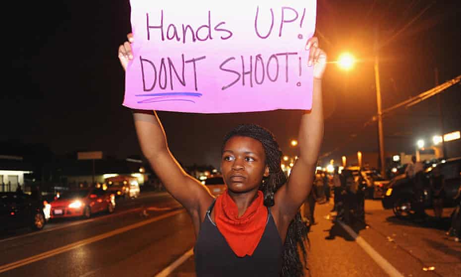 Protestors hold signs in Ferguson