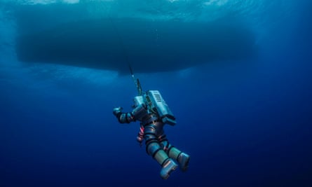 A diver wearing a robotic exosuit explores the site of the wreck called the Titanic of the ancient world