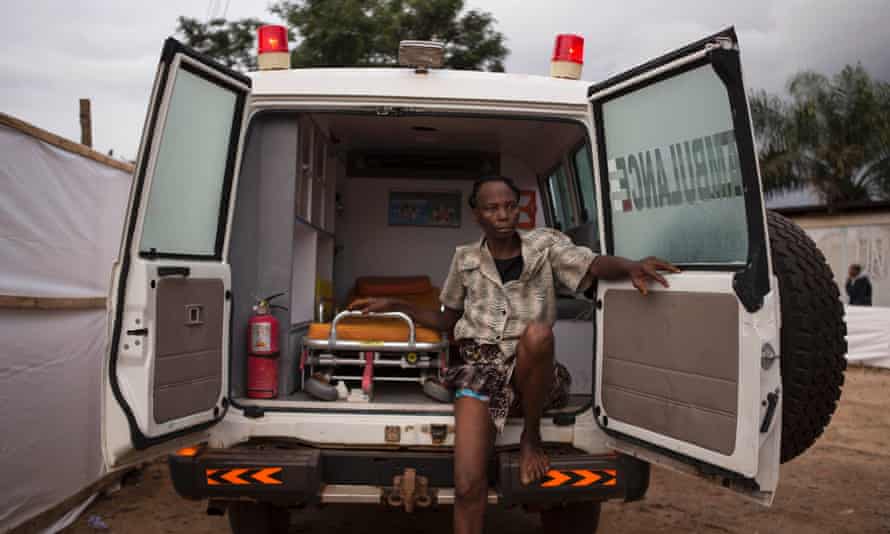 A woman suspected of suffering from the Ebola virus sits in an ambulance in Kenema in Sierra Leone.