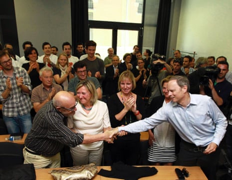 French economist and Nobel Prize laureate Jean Tirole, right, is congratulated by colleagues at the Toulouse School of Economics in Toulouse, southern France, Monday, Oct. 13, 2014