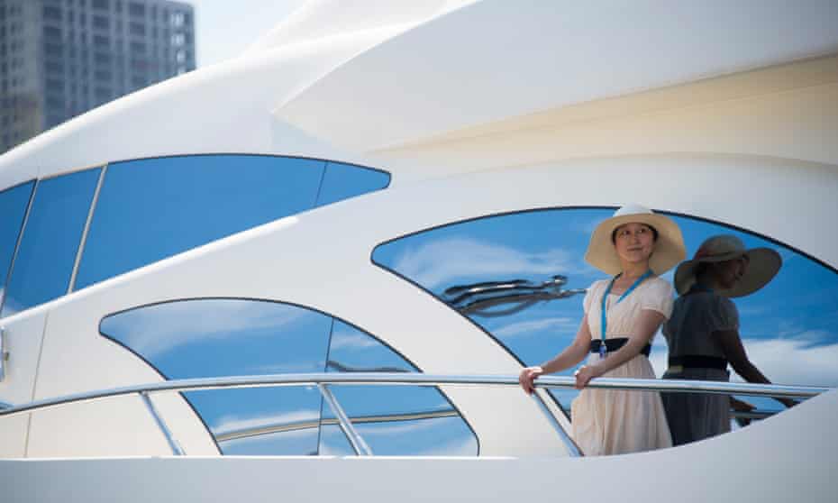 A model on a luxury yacht at a boat show in the port of Dalian.