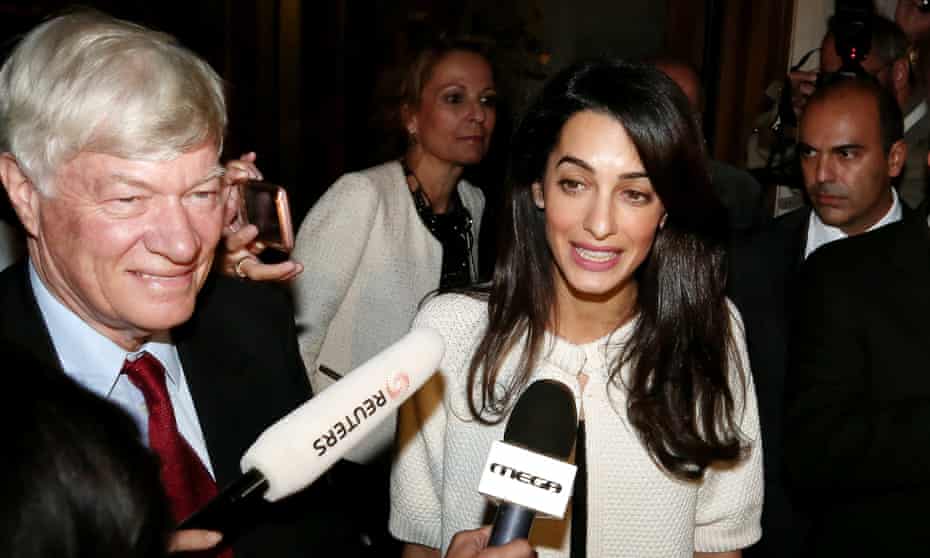 Lawyer Amal Alamuddin Clooney with lawyer Geoffrey Robertson talking to reporters outside the Hotel Grande Bretagne entrance.