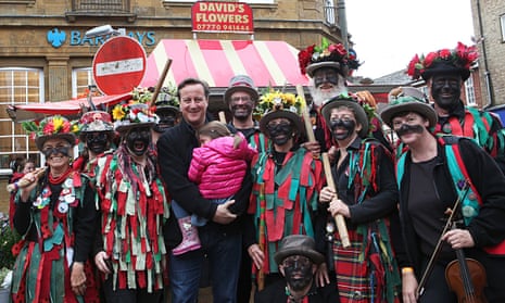 David Cameron poses with black-faced morris dancers