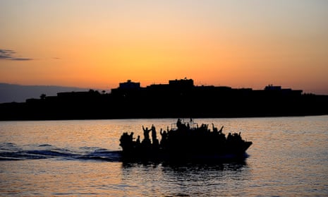 A boat carrying migrants enters the port of Lampedusa.