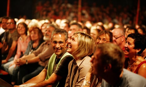 Audience watching a show in a small theatre