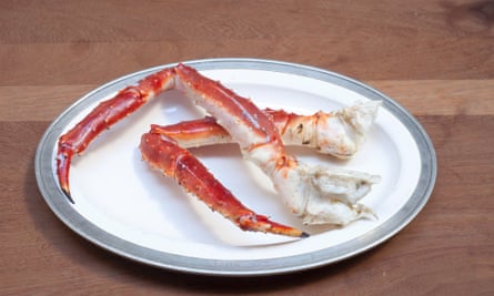 Two crab legs bent on a plate.