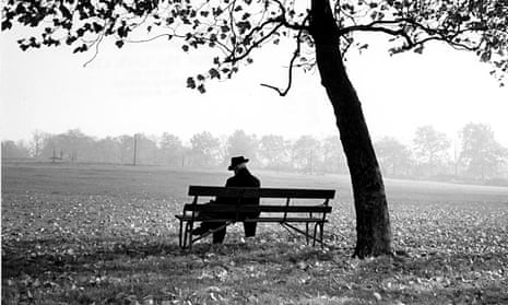 Man sitting on a bench under a tree
