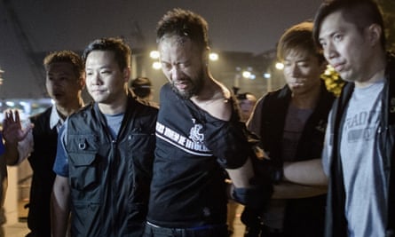 Ken Tsang, a Hong Kong pro-democracy activist, is taken away by police before they were filmed beating him in a side street.