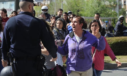 Occupant of an abandoned building shouts at a police officers during her eviction in Seville