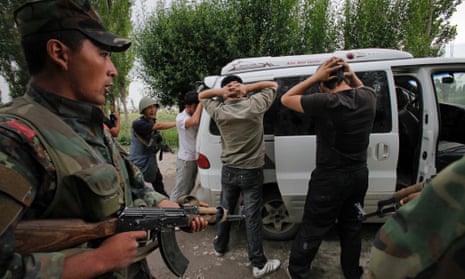 Kyrgyz soldiers check passing cars and search passengers for weapons at a check point on the Uzbek border in 2010. Both governments are now looking to rely more heavily on volunteers to perform such checks.