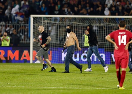 Ivan Bogdanov, left, invades the pitch during the game between Serbia and Albania this week.