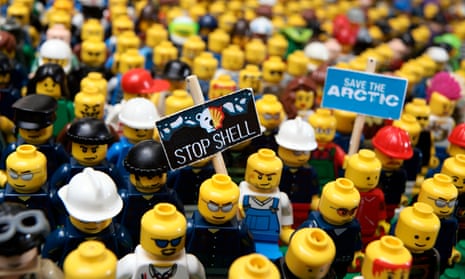 Lego figures fitted with protest banners, by Greenpeace activtists