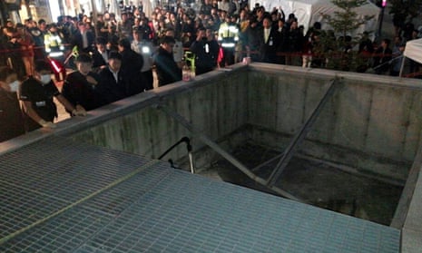 People gather around the collapsed ventilation grate at the venue in Seongnam, South Korea